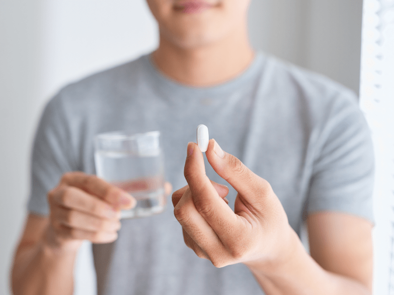 man holding Weiprost capsules for prostatitis